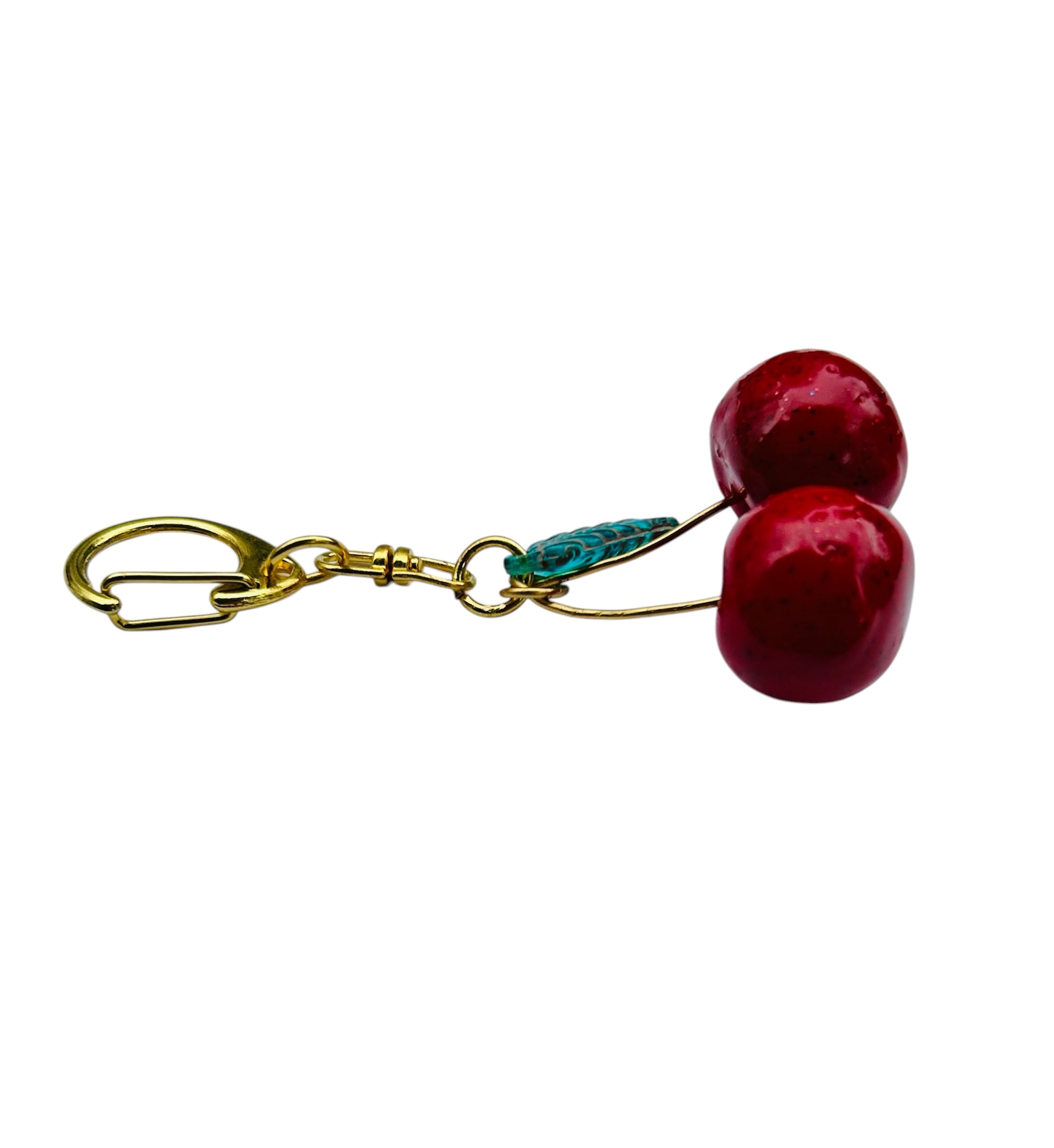 Cherry charm keychain with red clay cherries, epoxy gloss, green glass leaf bead, copper knot, gold-plated clasp.