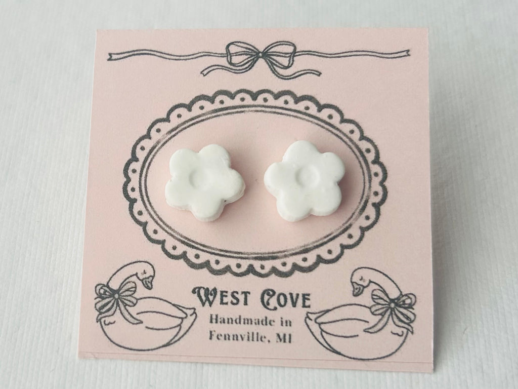 White daisy-shaped polymer clay earrings, 0.5 inch, hypoallergenic stainless steel backs, handmade in Fennville, MI.