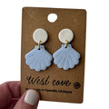 Polymer clay blue sea shell stud-dangle earrings with cream round tops on kraft card; hypoallergenic, coastal beachy style.