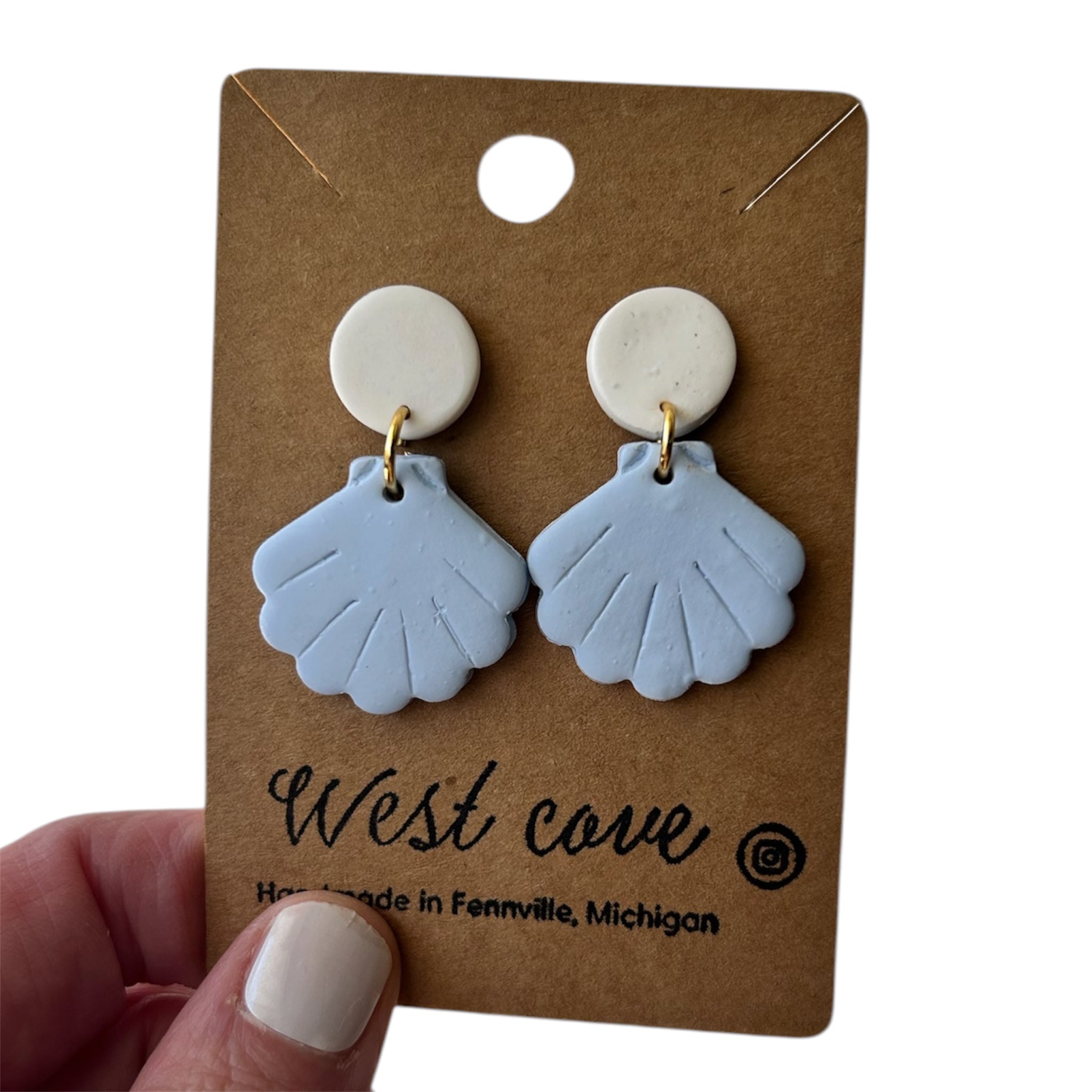 Polymer clay blue sea shell stud-dangle earrings with cream round tops on kraft card; hypoallergenic, coastal beachy style.