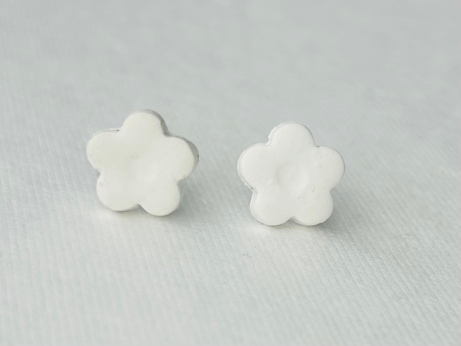 White daisy flower polymer clay earrings with hypoallergenic stainless steel backs, handmade in Michigan.