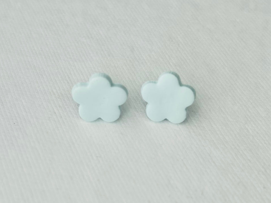 Light blue daisy polymer clay earrings with stainless steel hypoallergenic backs, handmade in Fennville, MI.