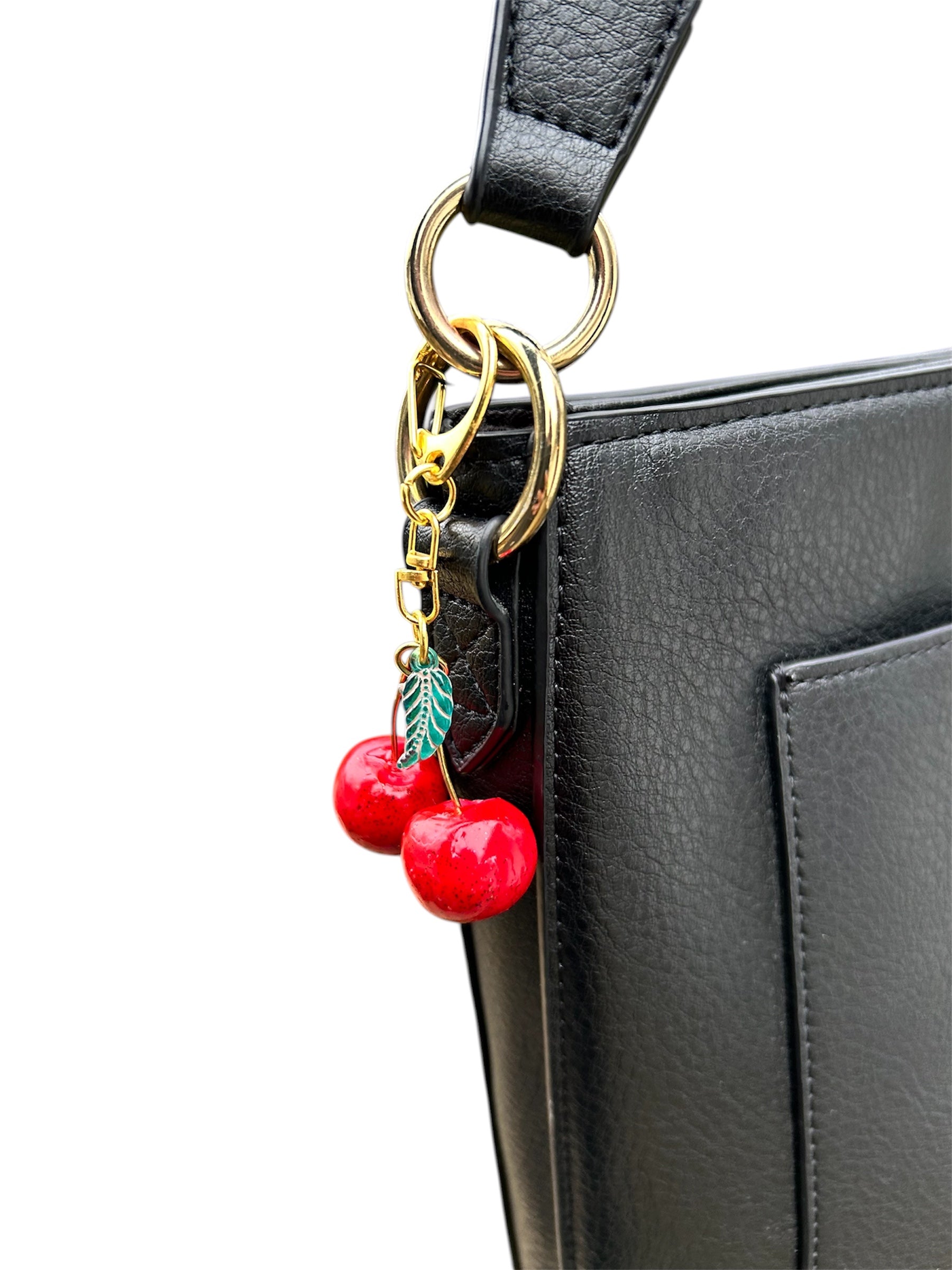 Cherry charm keychain: epoxy-coated red polymer cherries, green glass leaf bead, copper knot, gold-plated clasp chain.