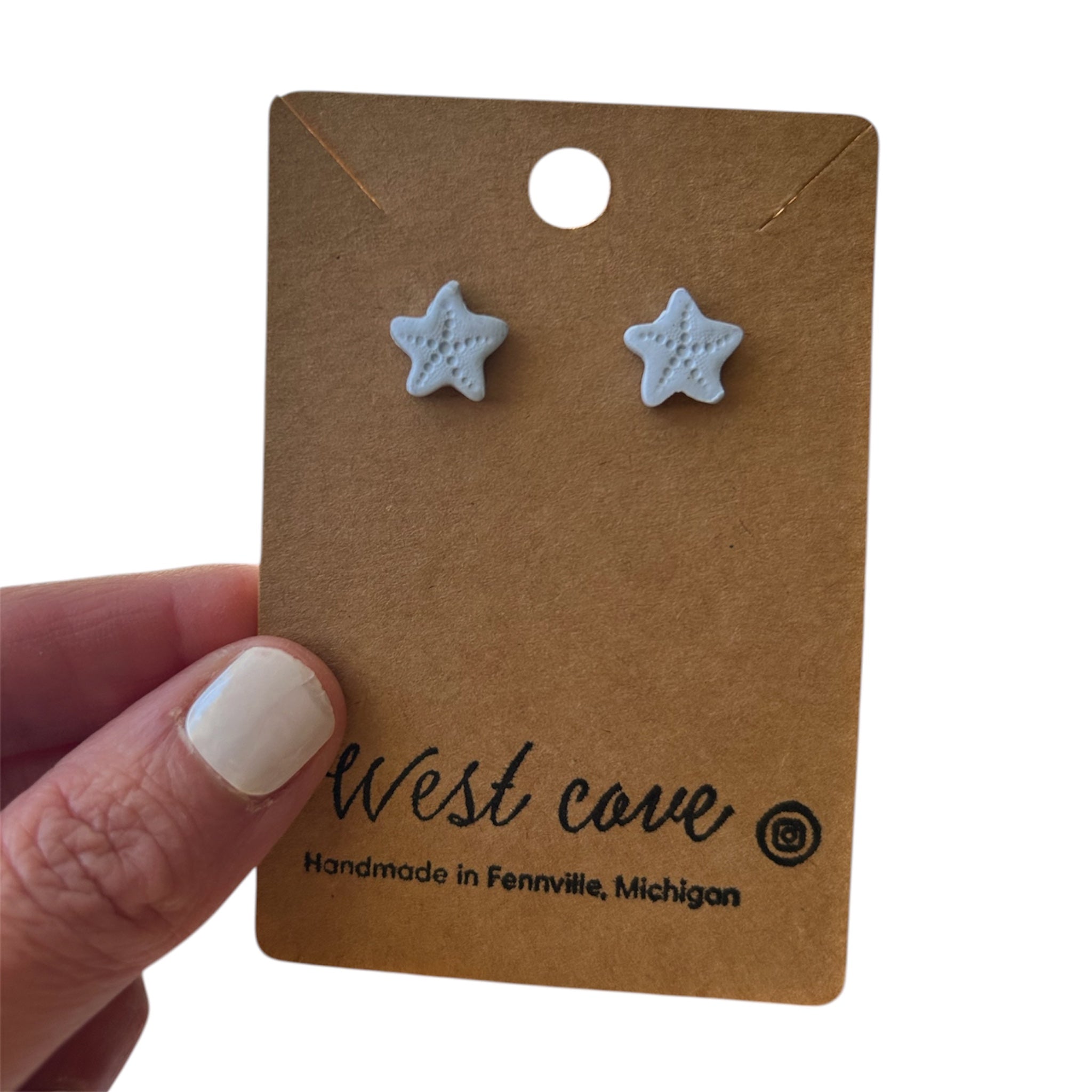 Light blue polymer clay starfish stud earrings on kraft display card, coastal beach jewelry.