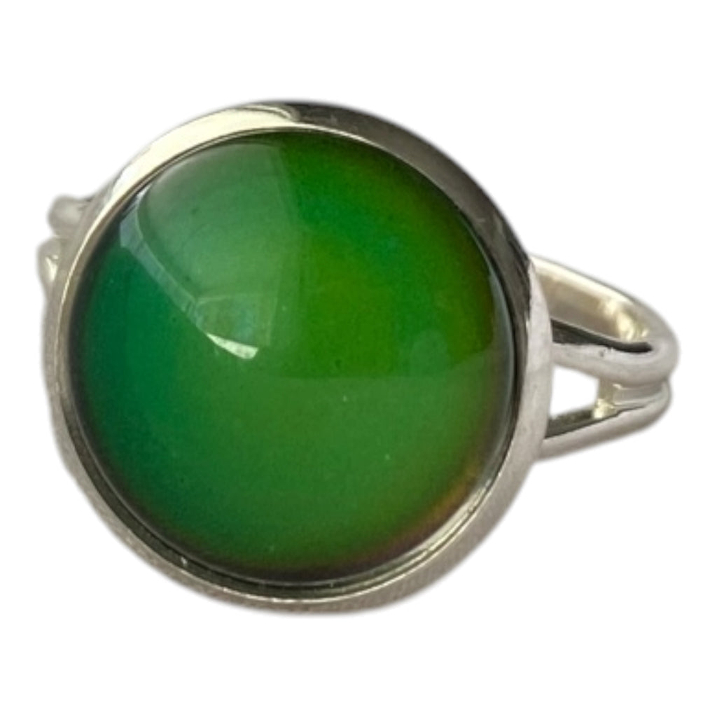 Mood ring with a green gemstone set in a silver band.