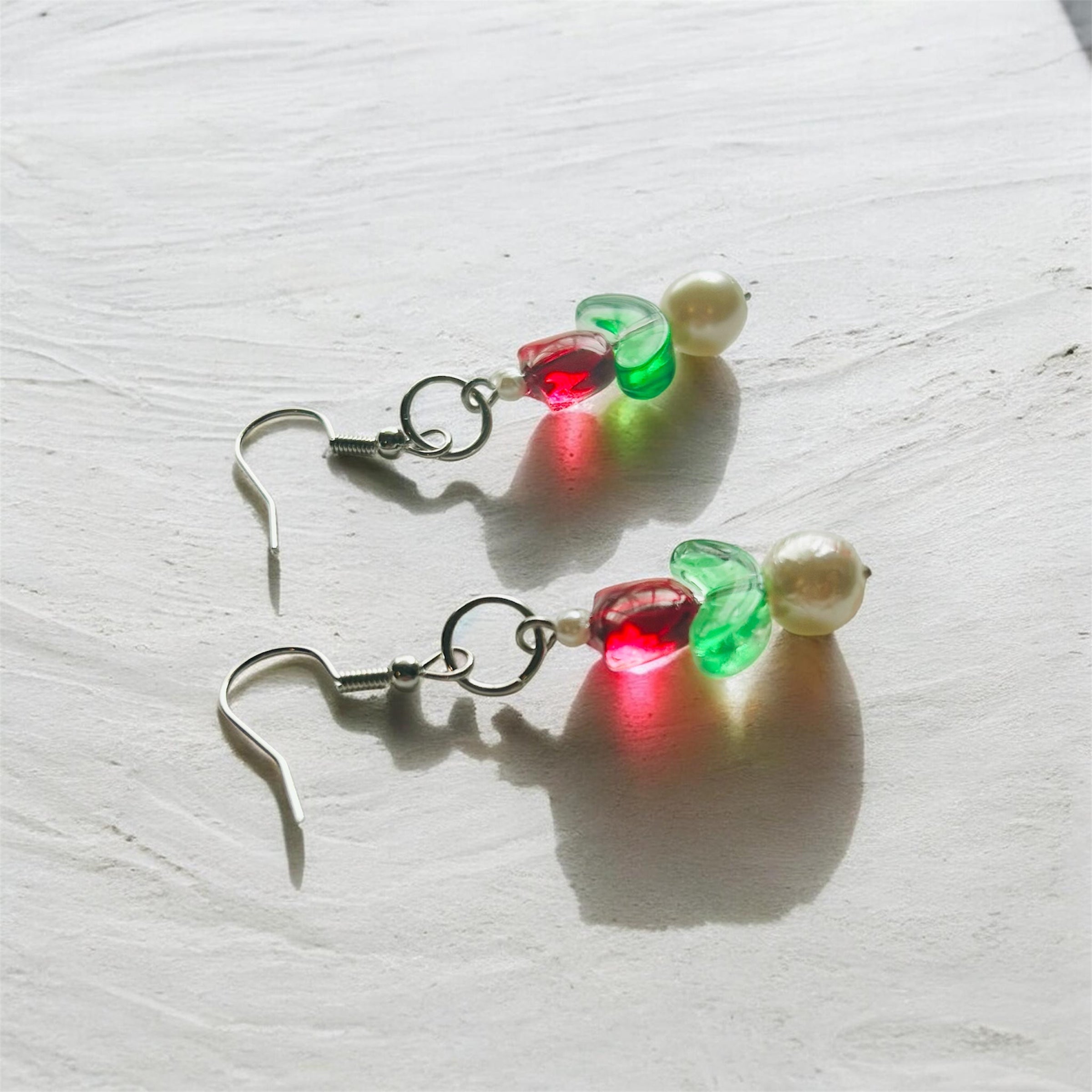 Beaded tulip earrings on sterling silver hooks with red, green, and pearl beads.